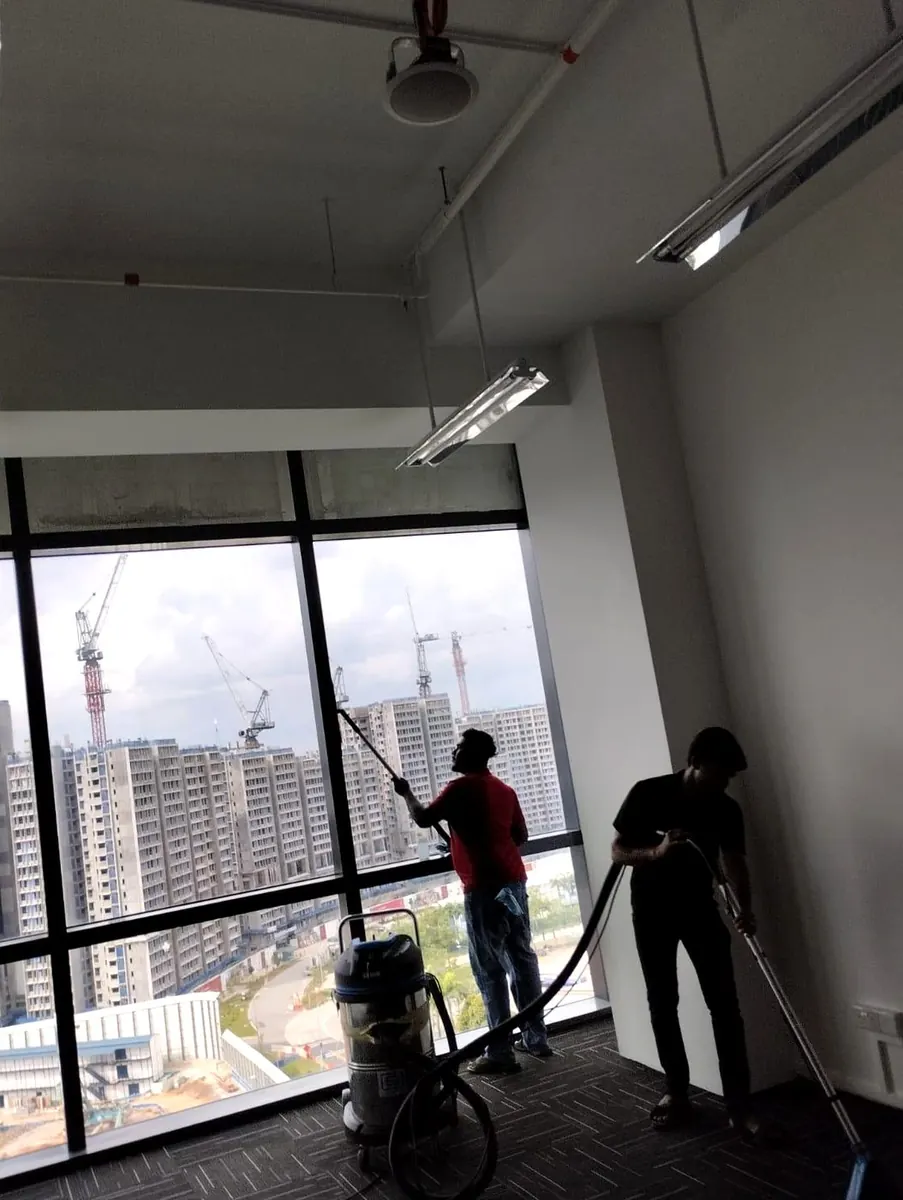 Imperial Services cleaning crew working in a high-rise commercial interior in Singapore