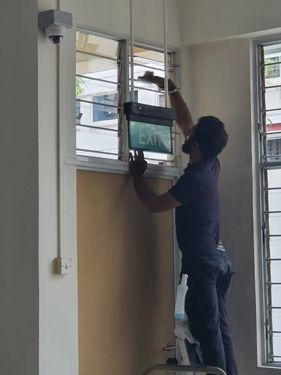 Imperial Services cleaner wiping interior window glass and frames